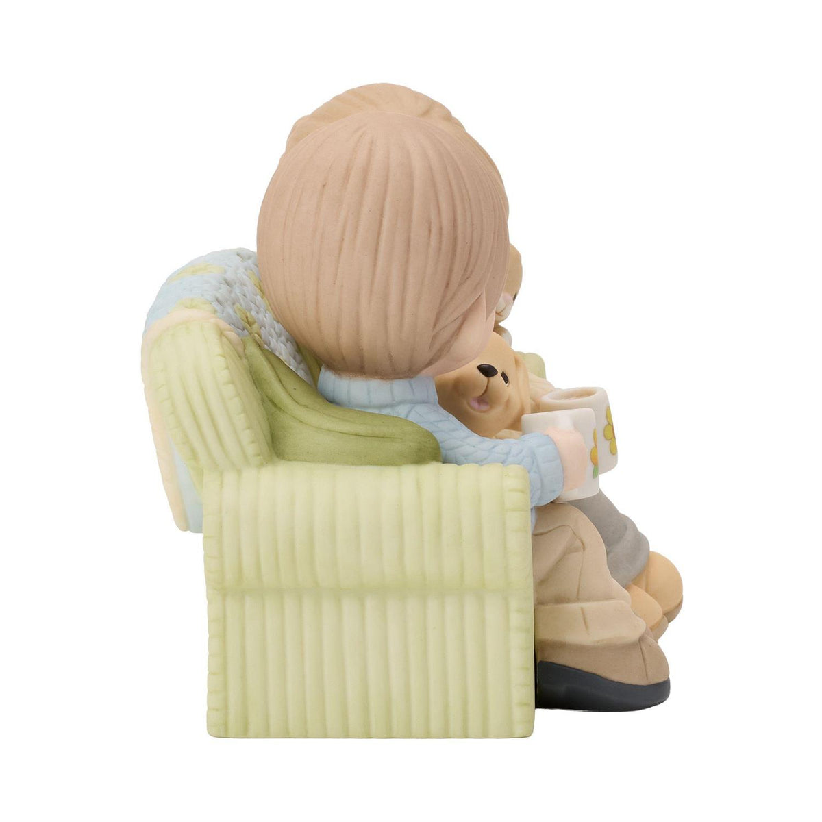 A couple sitting on the couch drinking coffee enjoying each others company along with a dog and cat