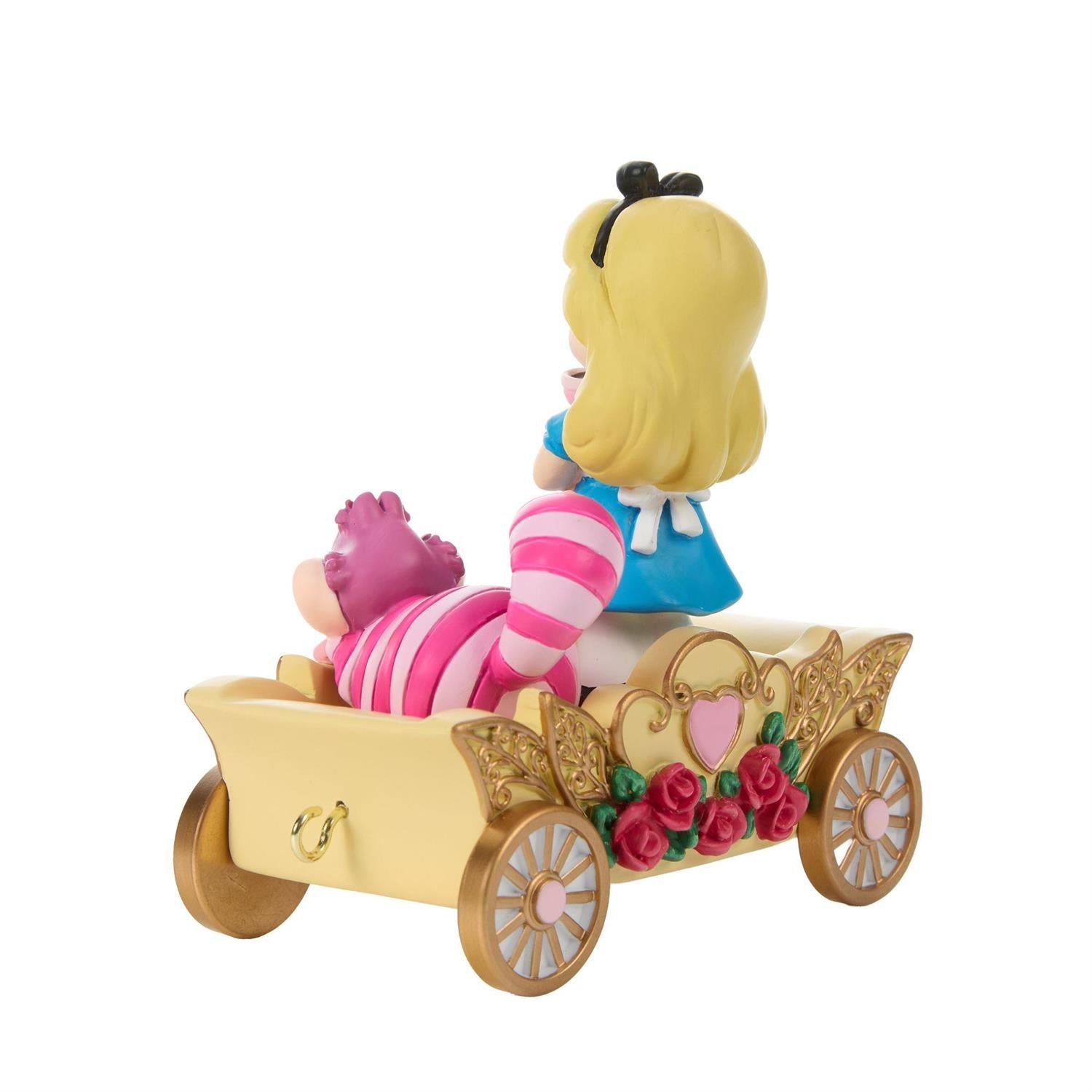 Alice holding a Tea Cup and the Cheshire Cat riding in a Birthday Train Car