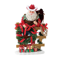 Buy Possible Dreams at CountryNMoreGIfts.com Santa standing next to a fence with a Cowboy hat on holding his toy bag over his shoulder