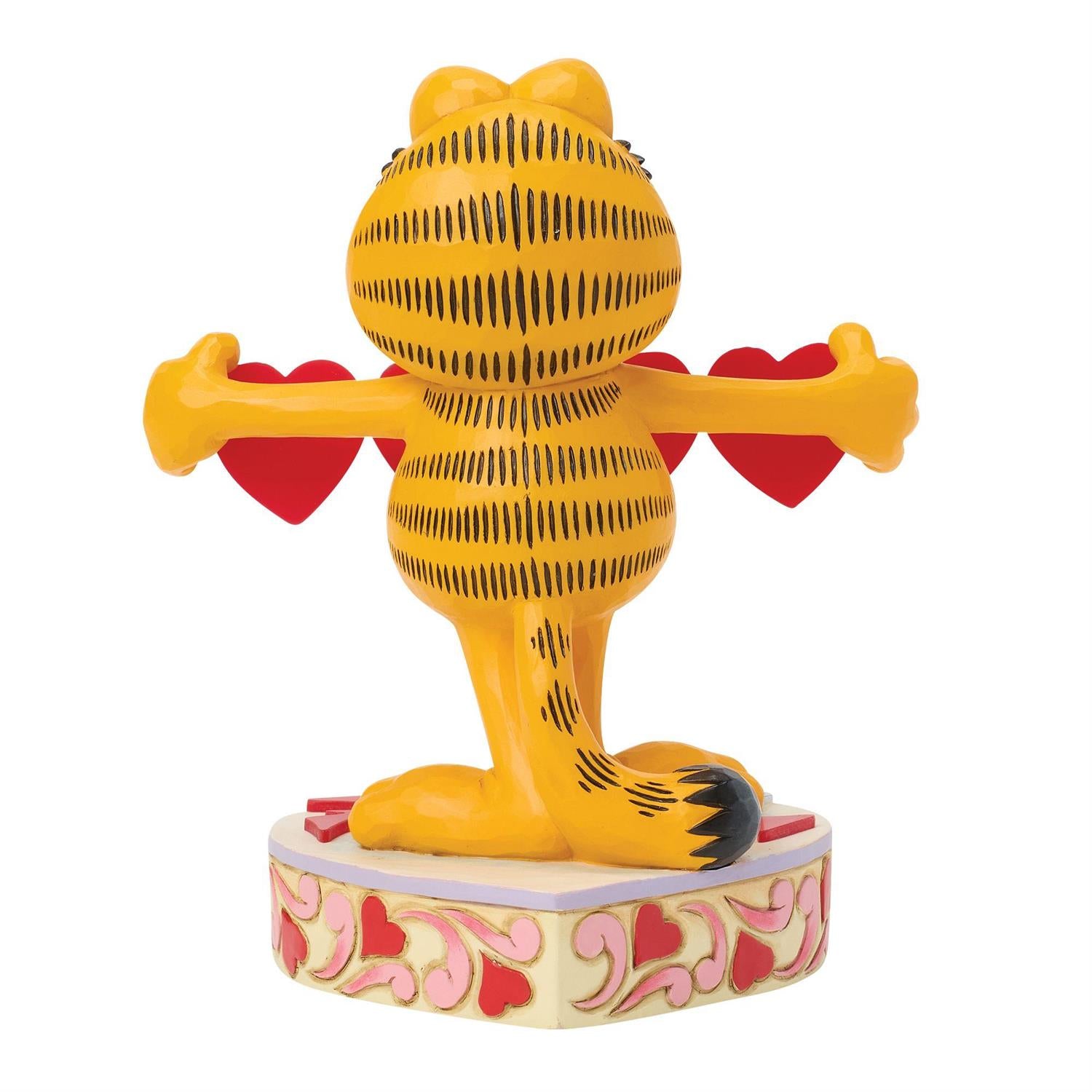 Garfield standing on a heart podium holding a string of hearts