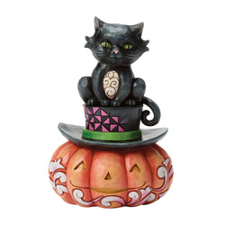 Buy Jim Shore decorative figurine of a black cat on a pumpkin with a colorful hat from CountryNMoreGifts.com