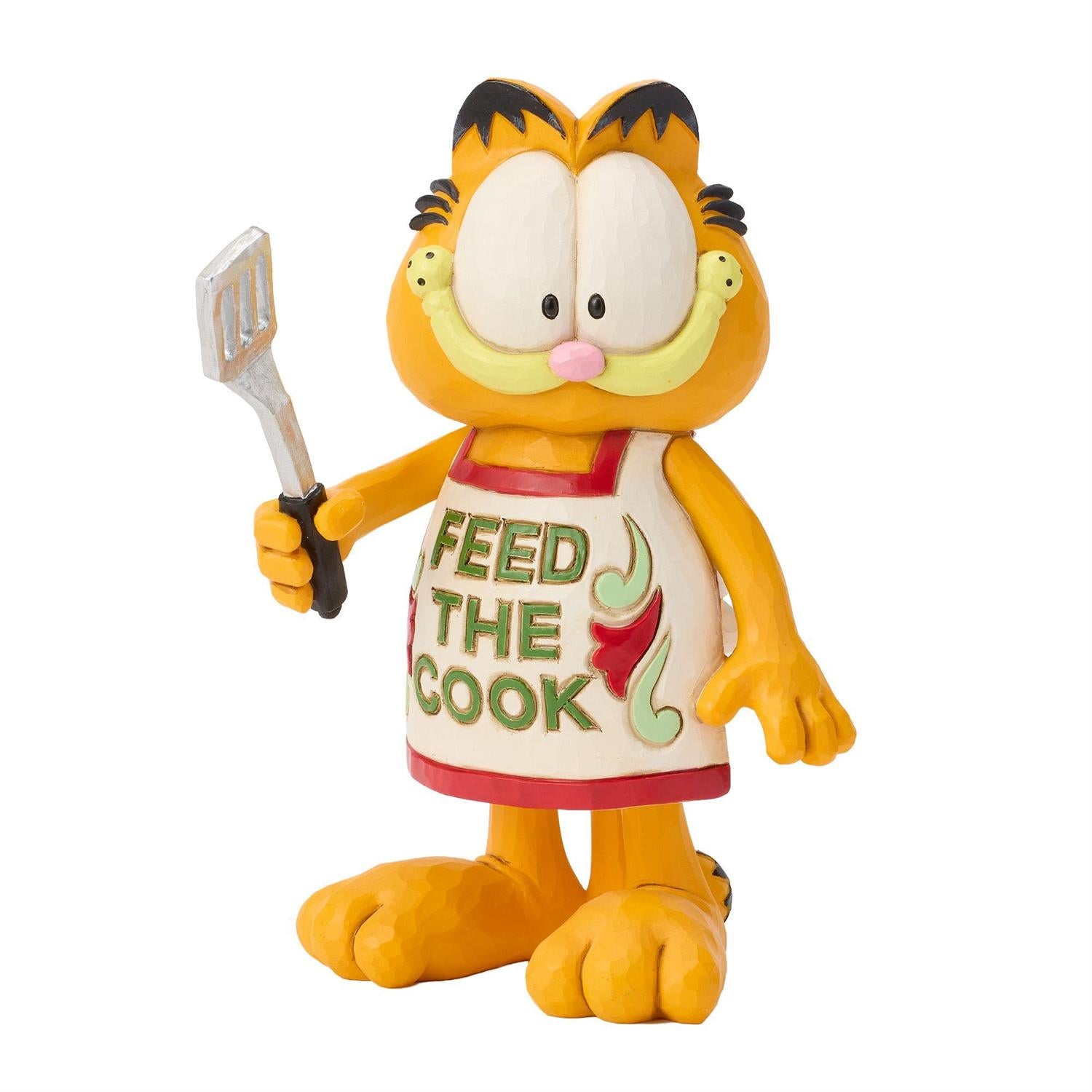 Garfield wearing a Feed the Cook Apron holding a Spatula