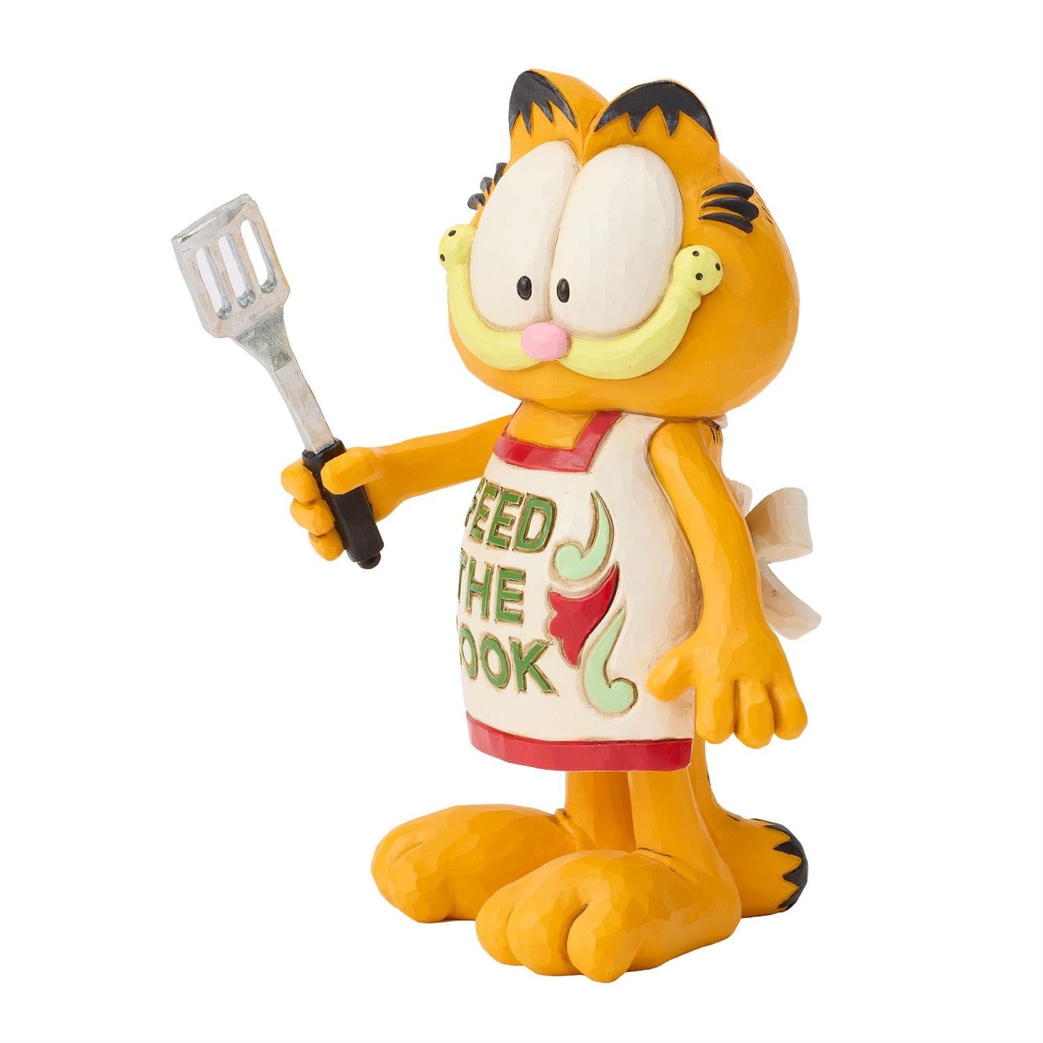 Garfield wearing a Feed the Cook Apron holding a Spatula