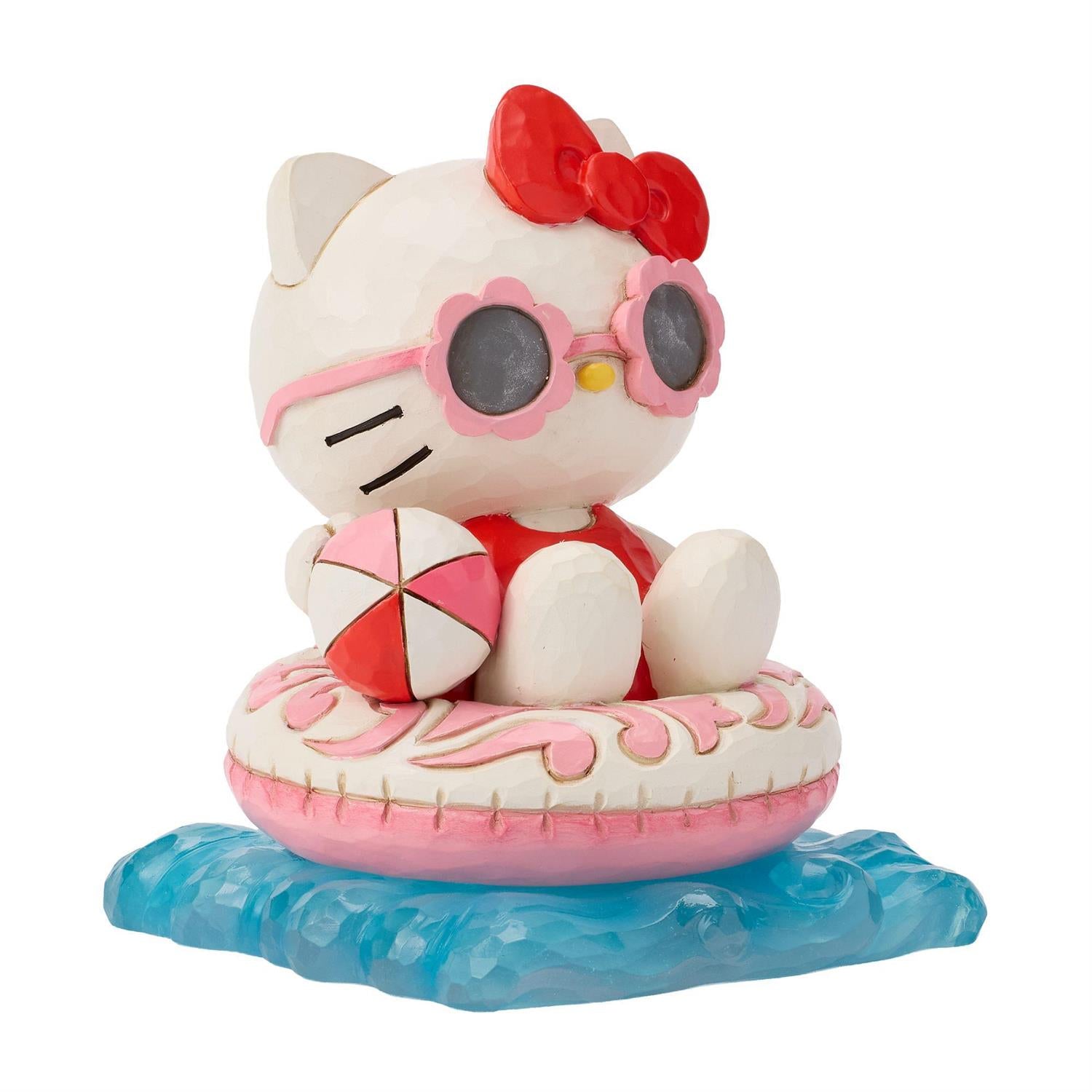 Hello Kitty wearing her shades, relaxing in her Floatie and holding a beach ball