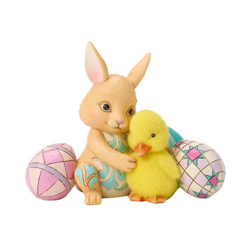 Bunny hugging a Duckling surronded by Easter Eggs