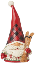 Decorative gnome figurine with a red hat and skis on a white background